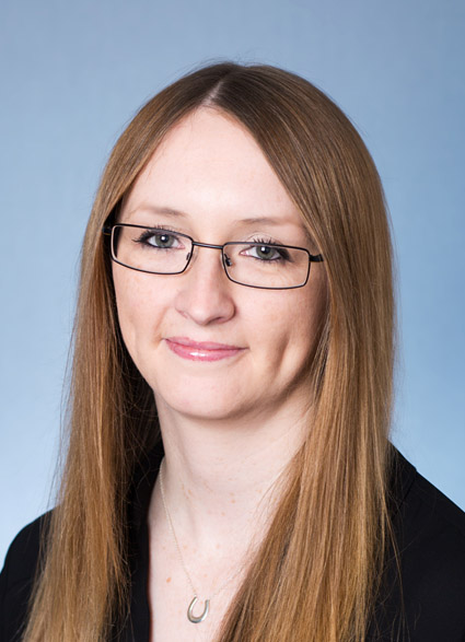 Headshot image of Laura Williams wearing glasses and looking at camera